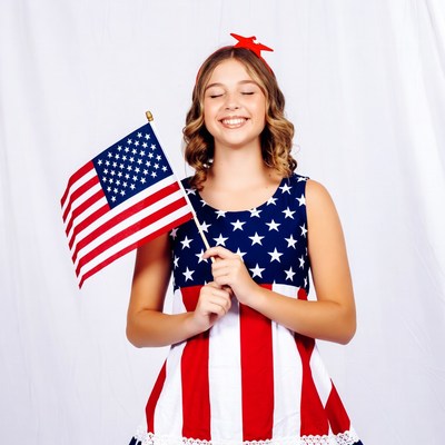Girl holding American flag smiling