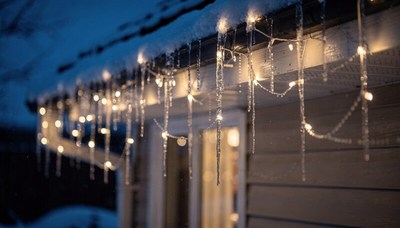 Icicles and Christmas Lights on Snowy Roof