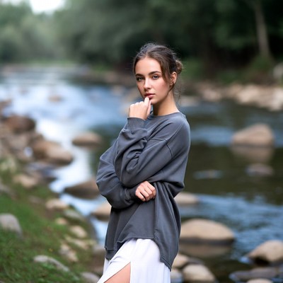 Young woman by riverside in forest