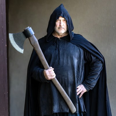Man in black hood holding axe