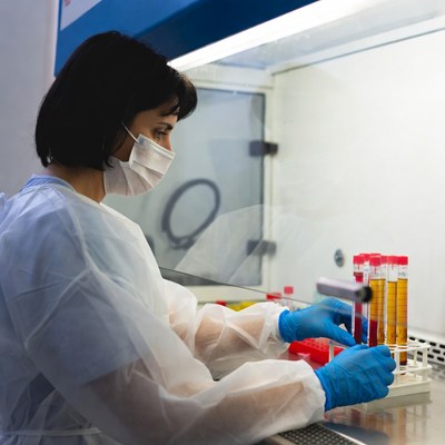 Woman scientist handling test tubes in lab