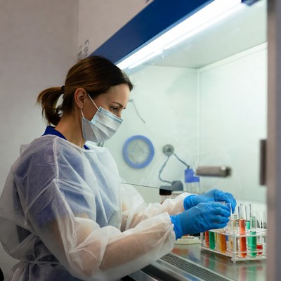 Woman scientist working in lab biosafety cabinet