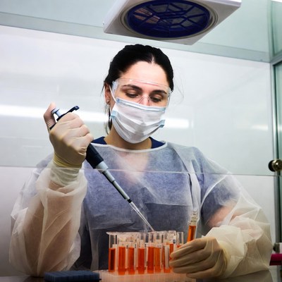 Woman scientist pipetting in lab
