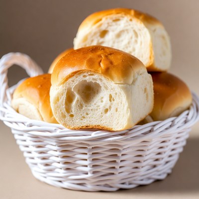 Fresh bread rolls in white basket