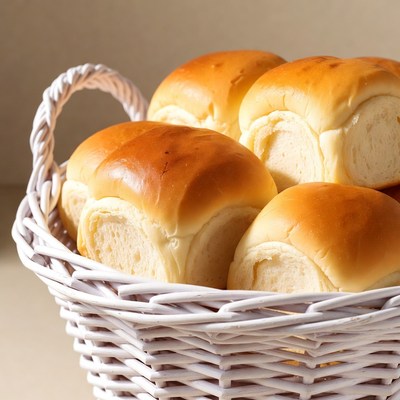 Fresh bread rolls in white basket