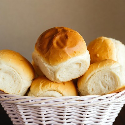 Fresh bread rolls in white basket