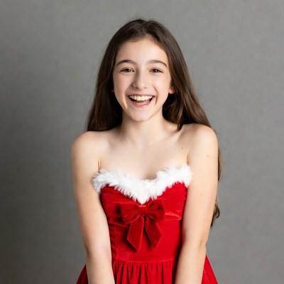 Girl smiling in red Santa dress