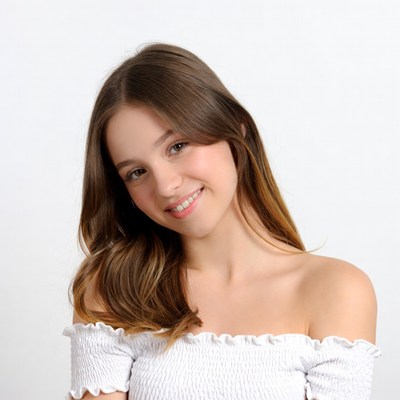 Smiling young woman in white off-shoulder top