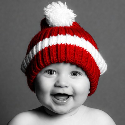 Baby smiling in red Santa hat