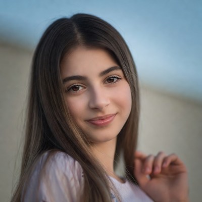Young woman with long brown hair smiling