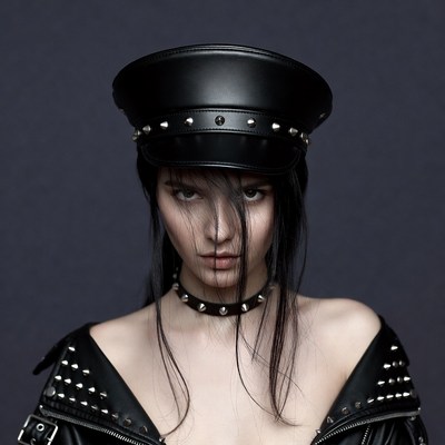 Woman in spiked leather hat and jacket