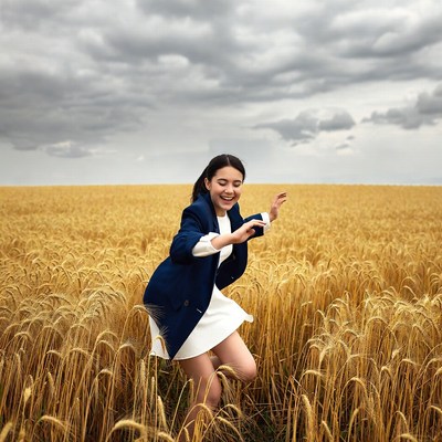 Woman dancing in golden wheat field