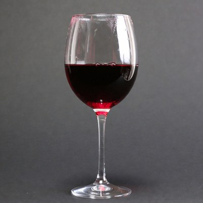 Red wine glass on black background