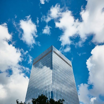 Skyscraper Reflecting Blue Sky Clouds