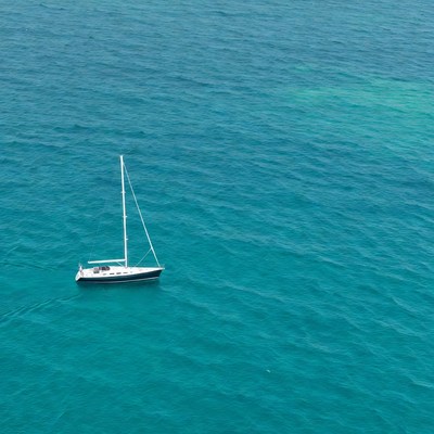 White sailboat on turquoise ocean