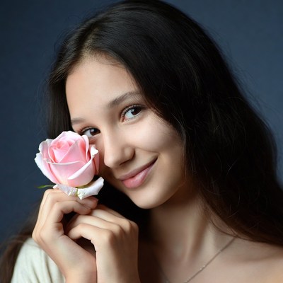 Young woman holding pink rose