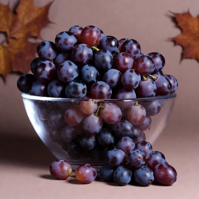Purple Grapes in Glass Bowl with Autumn Leaves