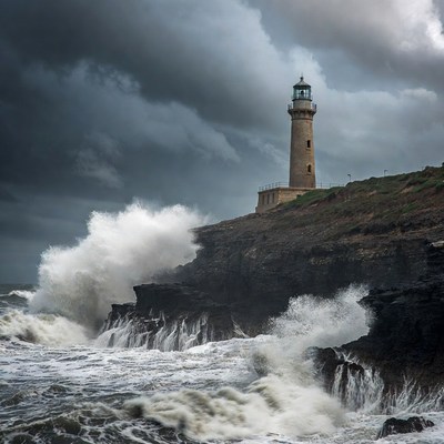 Lighthouse on Cliff Amid Crashing Waves