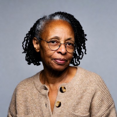 African-American woman with gray braids and glasses