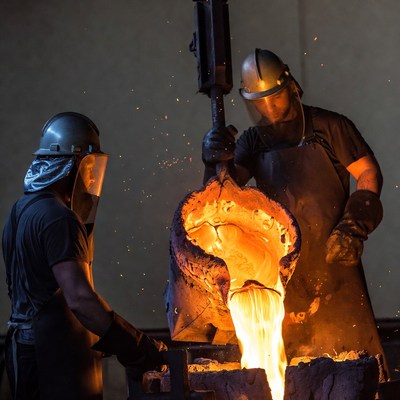 Workers Pouring Molten Metal Foundry