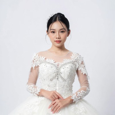Asian bride in lace wedding gown