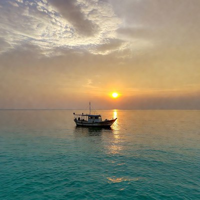 Fishing Boat at Sunset Over Sea