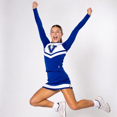 Cheerleader jumping with arms raised