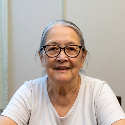 Elderly Asian woman smiling with glasses