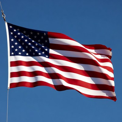 American flag waving against blue sky