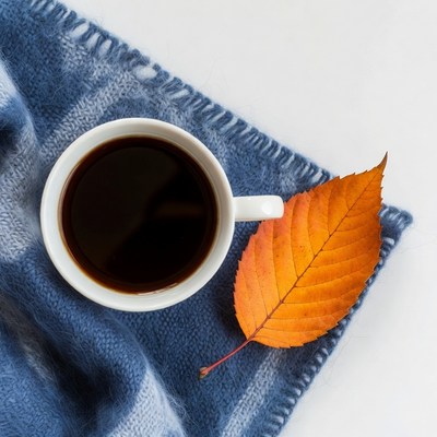 Coffee cup with autumn leaf