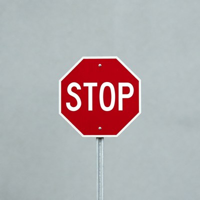 Red Stop Sign on Gray Background