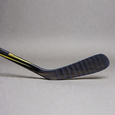 Black hockey stick with yellow stripe