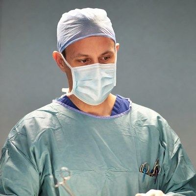 Surgeon in scrubs and mask