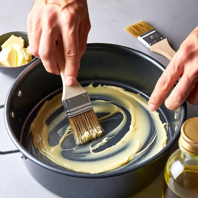 Man brushing butter in pan