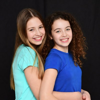 Two smiling girls hugging