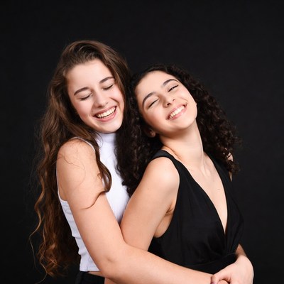Two girls hugging and smiling