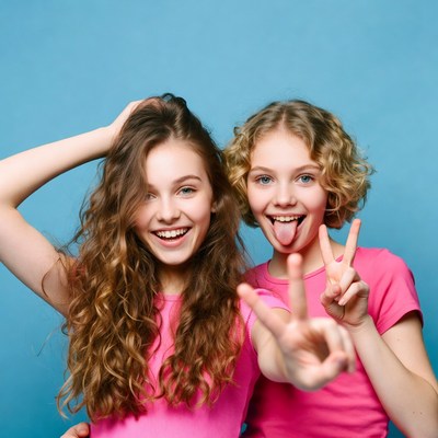 Two girls making peace signs