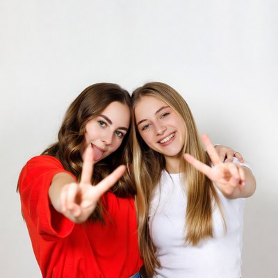 Two girls making peace signs