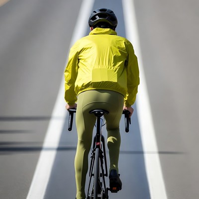 Man cycling on road in yellow gear