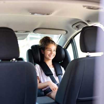 Girl smiling in car seat