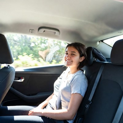 Smiling teenage girl in car