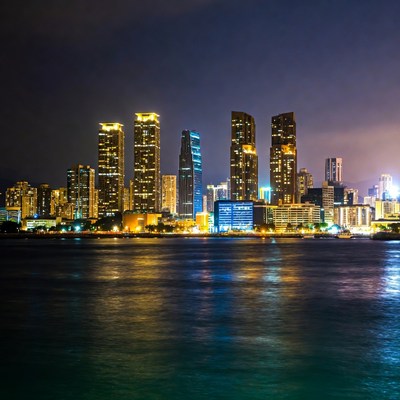 City skyline reflecting on water at night
