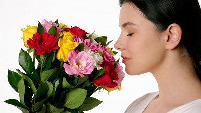 Woman smelling colorful bouquet