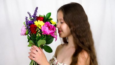 Girl smelling colorful bouquet