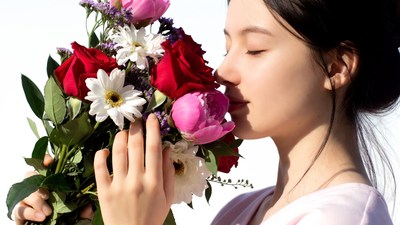 Woman smelling colorful bouquet
