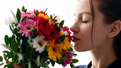 Woman smelling colorful bouquet