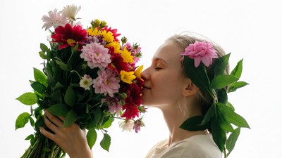 Woman kissing colorful bouquet