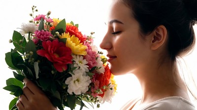 Asian woman smelling colorful bouquet