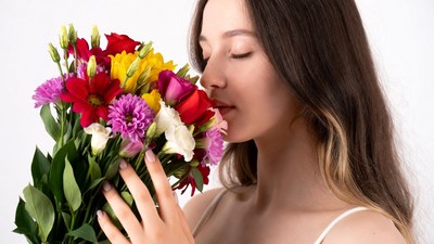 Woman smelling colorful bouquet