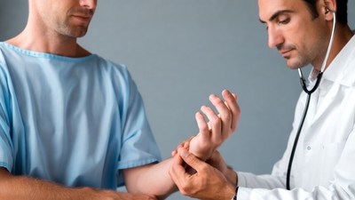 Doctor examining patient's wrist